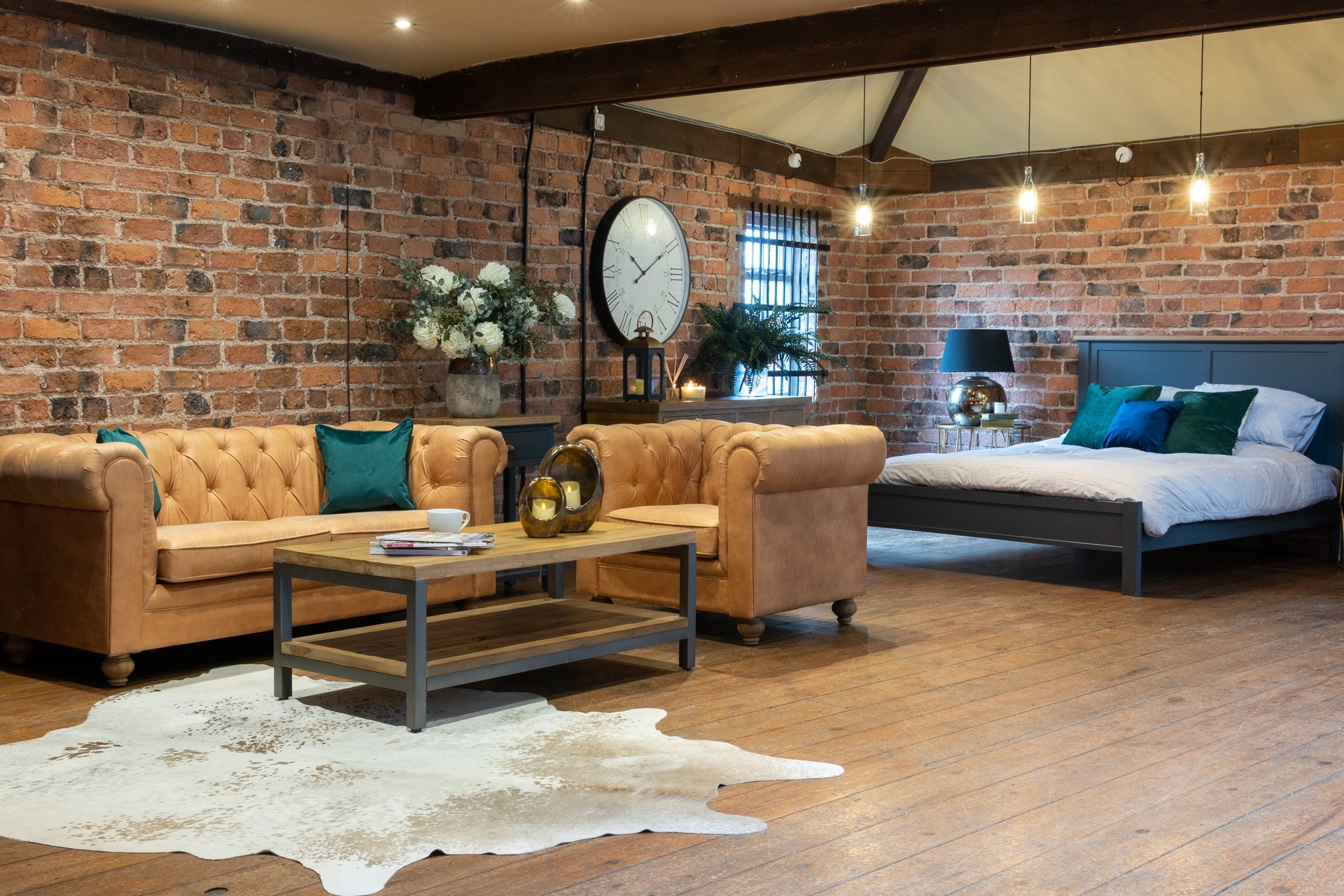 Living room with brick walls, wooden floor, and modern furniture.